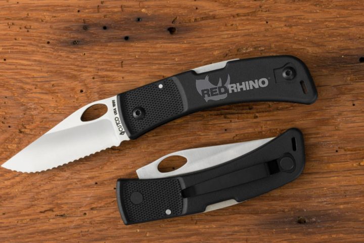 Pocket knife engraved with a company logo on the handle