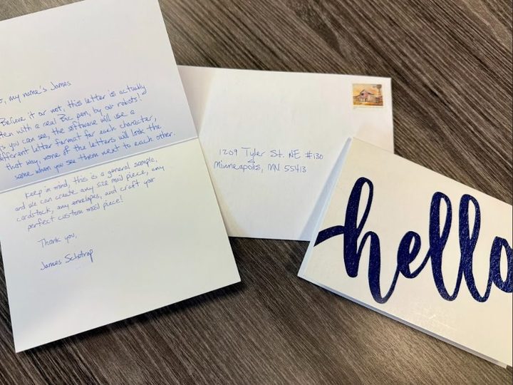 Handwritten note cards and an addressed envelope on a wood desk