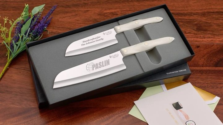 Boxed engraved pair — company logo on one blade, the recipient family name on the other