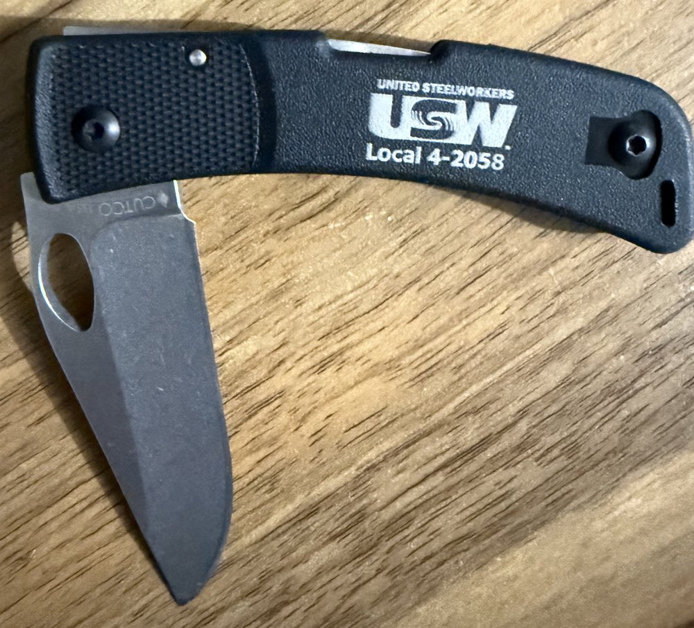 Lockback pocket knife engraved with a union local logo on the handle